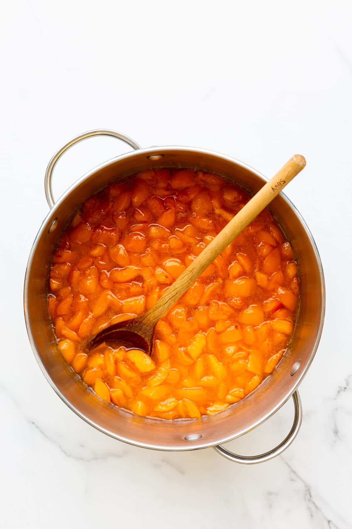 A pot of apricot marmalade after macerating the fruit and before boiling it to the jam setting point.