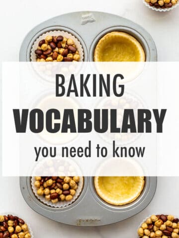 Blind baked tart shells in a muffin pan with silicone liners and dried beans to illustrate baking vocabulary you need to know.
