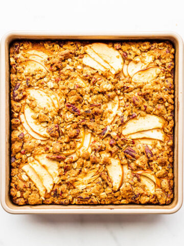 An apple cake baked in a square baking pan.