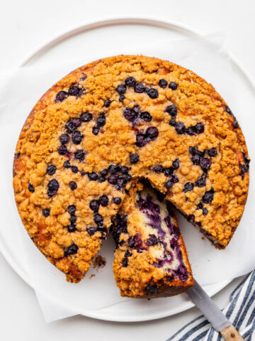 Slicing a blueberry crumb cake.