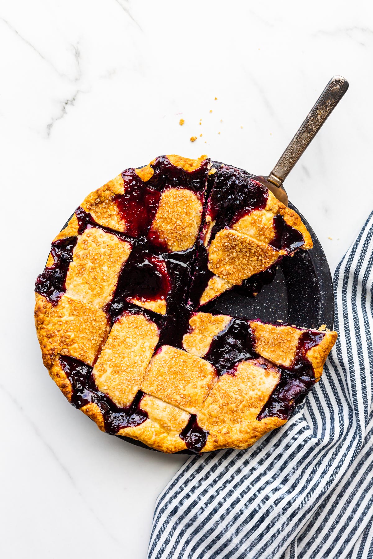 Freshly baked blueberry pie being served.