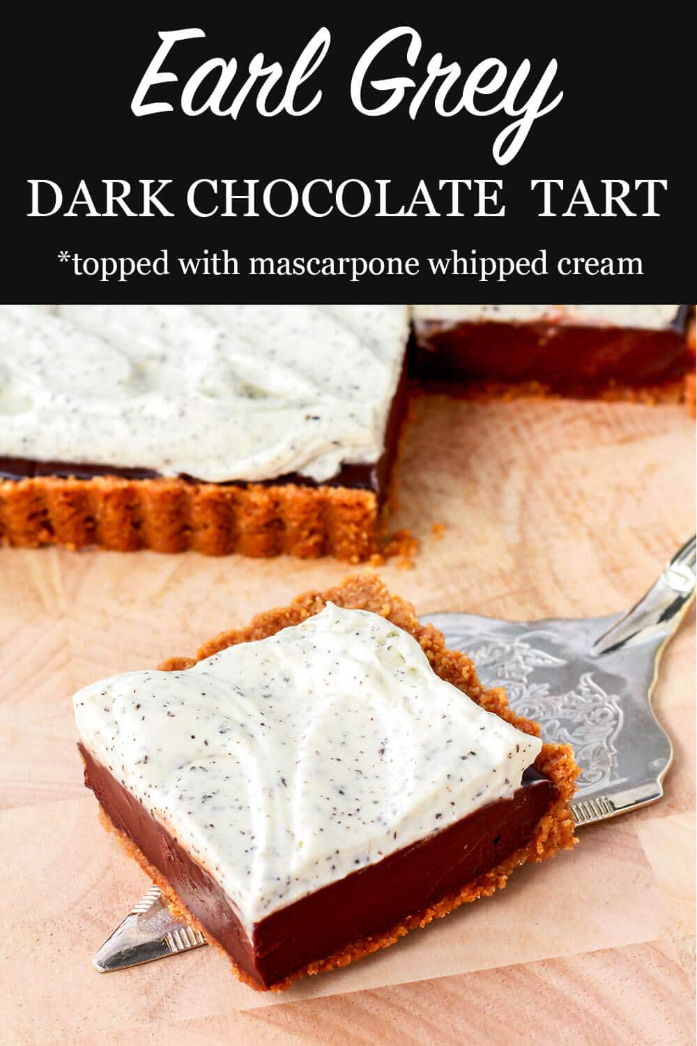 Square tart filled with dark chocolate ganache and topped with whipped cream flecked with Earl Grey tea leaves