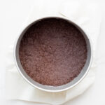 Oreo cookie crust baked in a springform pan for cheesecakes.