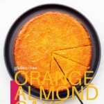 Slicing an orange cake to serve it.