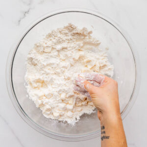 Working butter into flour with fingertips.