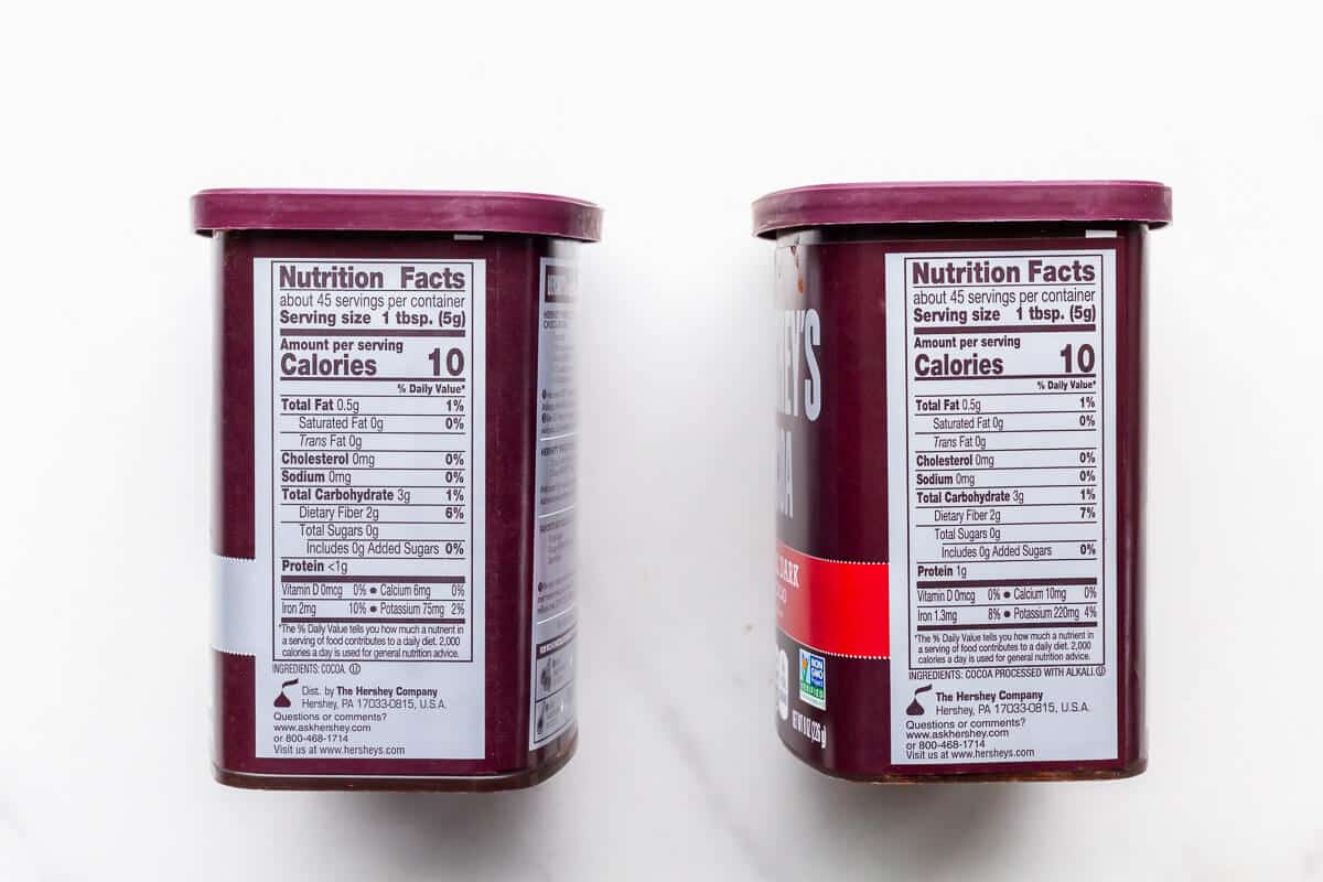 Nutrition labels and ingredients of natural and extra dark Hershey's cocoa powder.