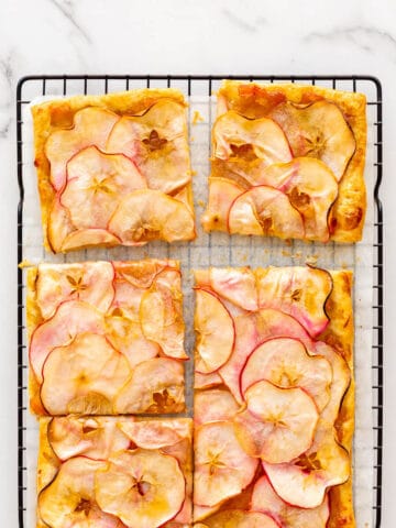 Puff pastry apple tart cut into squares to serve.