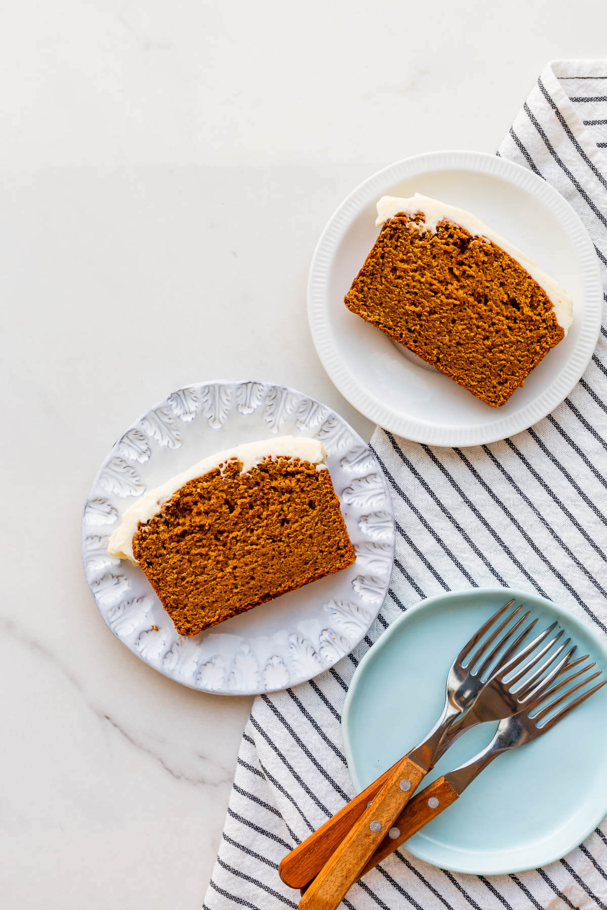 Slices of pumpkin bread on dessert plates, ready to be eaten.