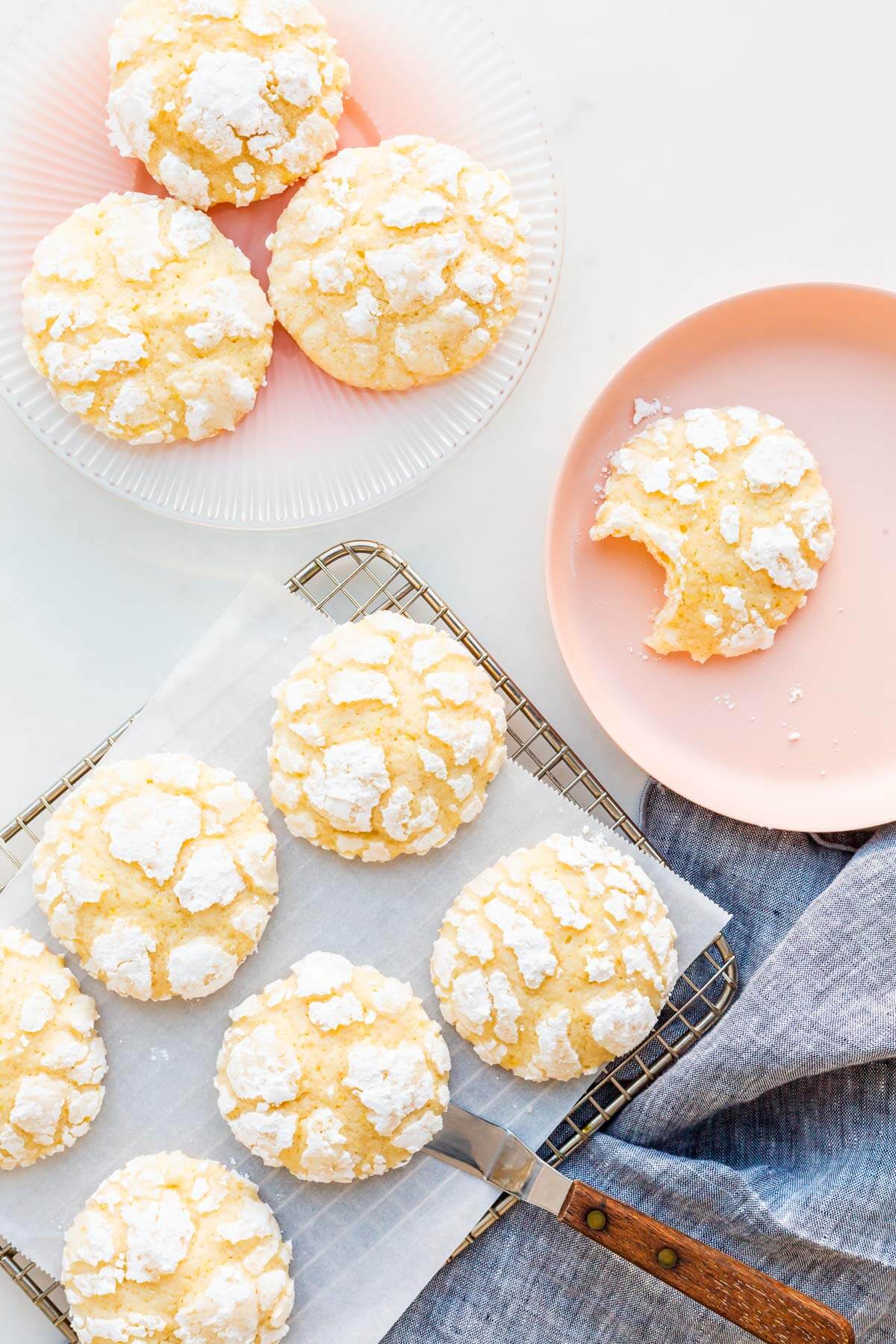 Lemon crinkle cookies on a cooling rack.